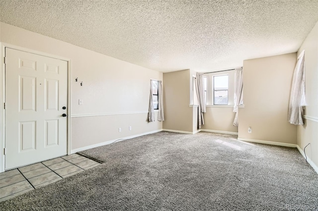 interior space featuring baseboards and a textured ceiling