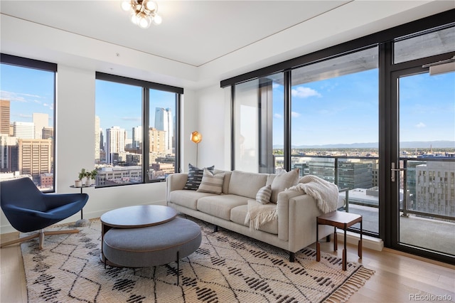 1750 Wewatta St Unit 1720, Denver, CO 80202 - living area featuring a skyline view, wood finished floors, and baseboards