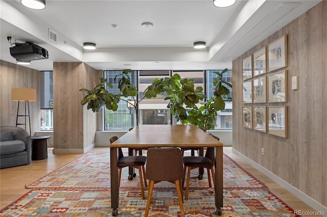 1750 Wewatta St Unit 1720, Denver, CO 80202 - dining room with wooden walls, light wood finished floors, baseboards, and a tray ceiling