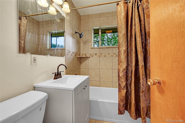 full bathroom featuring shower / tub combo with curtain, toilet, and vanity