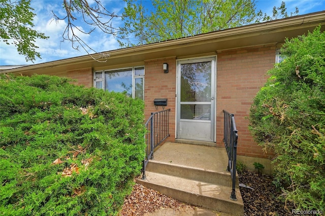 property entrance with brick siding
