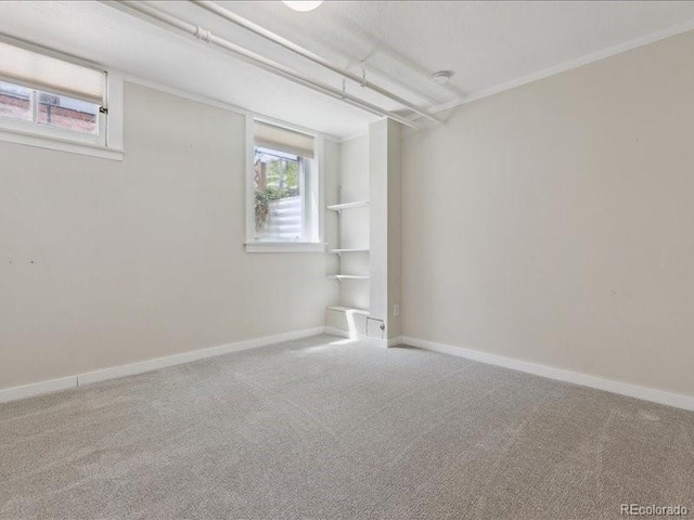 below grade area featuring carpet flooring and baseboards