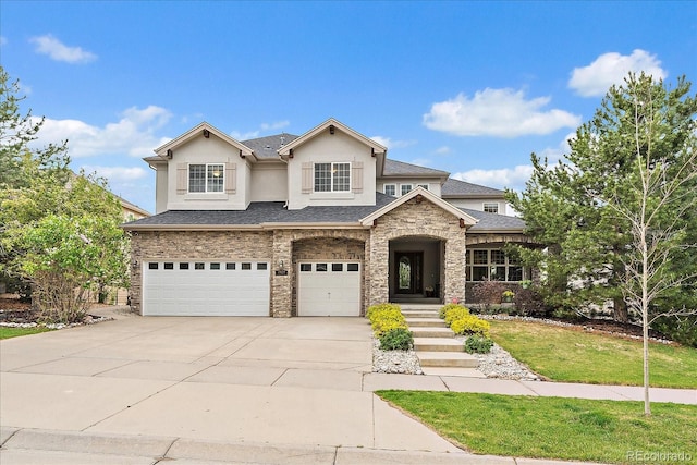 view of front of house with an attached garage, stucco siding, driveway, stone siding, and a front lawn