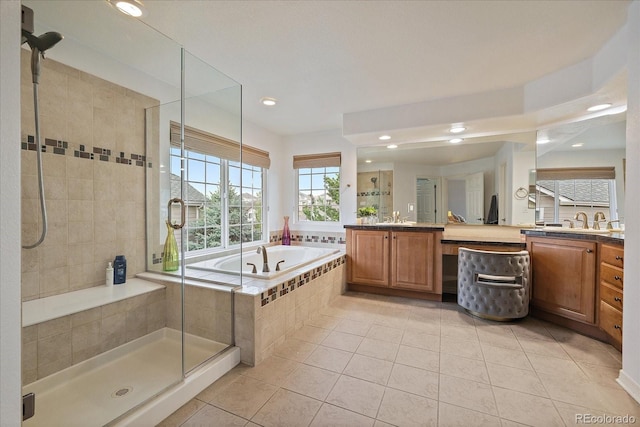 bathroom with tile patterned floors, a shower stall, a bath, vanity, and recessed lighting