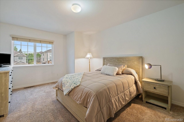 carpeted bedroom with baseboards