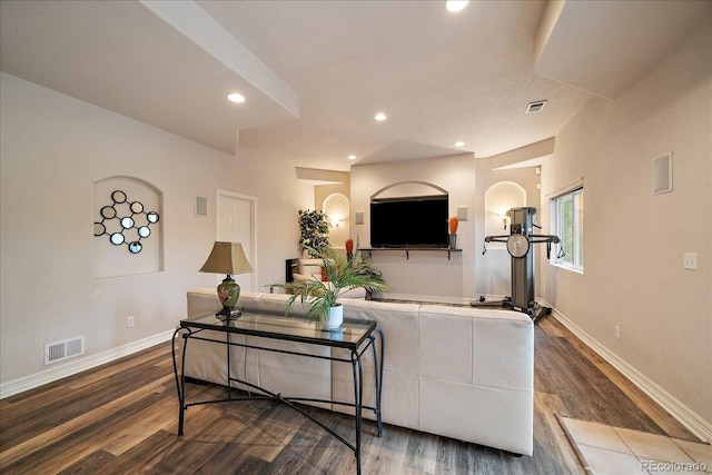 living room featuring wood finished floors, baseboards, and recessed lighting