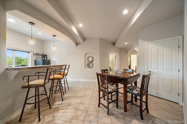 dining area featuring arched walkways, recessed lighting, light tile patterned flooring, and baseboards
