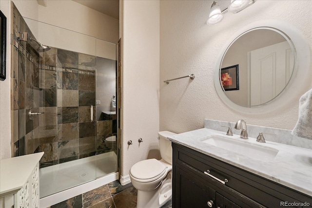 full bathroom with a shower stall, toilet, vanity, stone tile flooring, and a textured wall