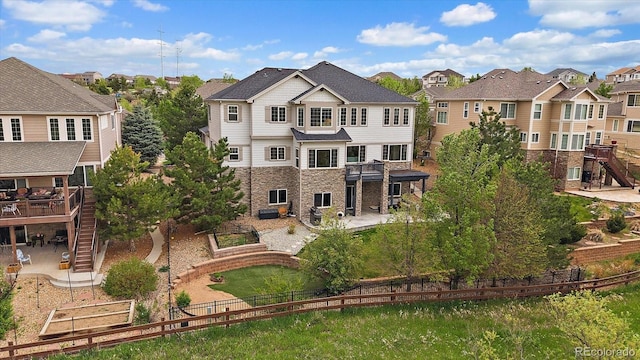 back of property with a patio, stairs, a residential view, and a fenced backyard