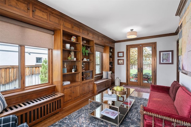 interior space featuring radiator, crown molding, wood finished floors, and french doors