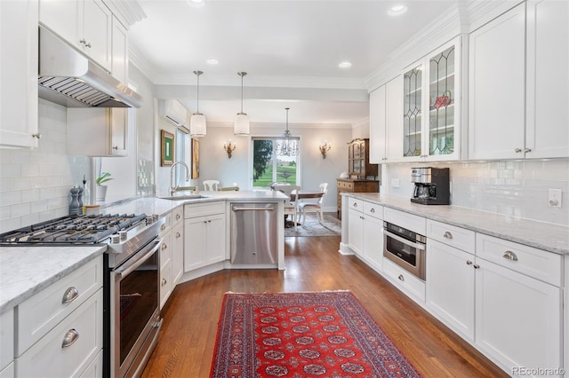kitchen with under cabinet range hood, a sink, a peninsula, stainless steel appliances, and white cabinets