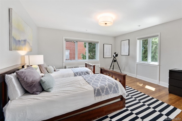 bedroom featuring baseboards and wood finished floors