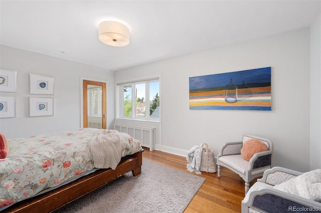 bedroom with wood finished floors and baseboards