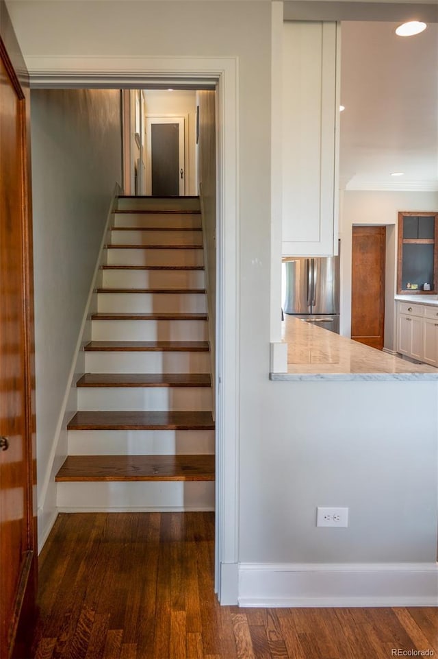 staircase featuring recessed lighting and wood finished floors