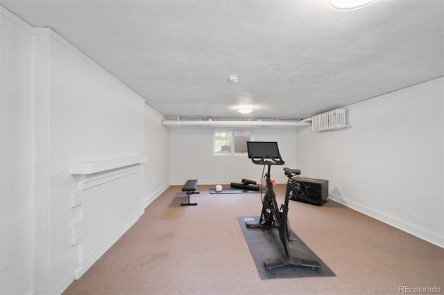 exercise room with baseboards and carpet