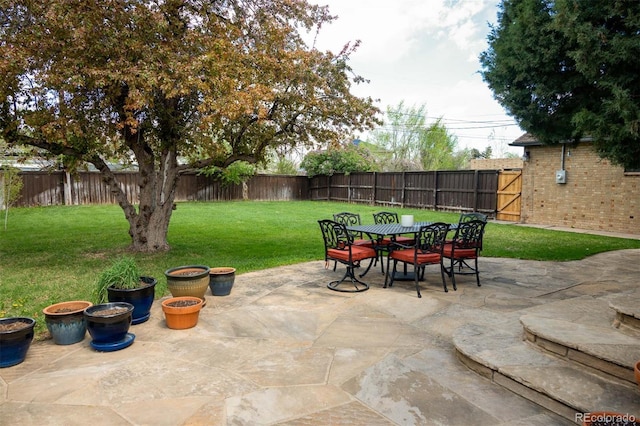 view of patio with a fenced backyard and outdoor dining area