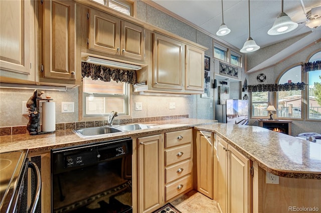 kitchen with kitchen peninsula, black dishwasher, plenty of natural light, and hanging light fixtures