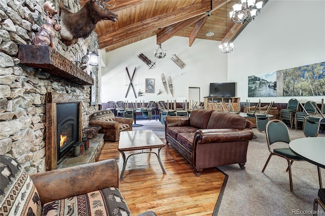 living room featuring wood-type flooring, wood ceiling, high vaulted ceiling, and a chandelier