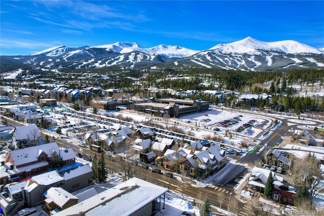 snowy aerial view with a mountain view