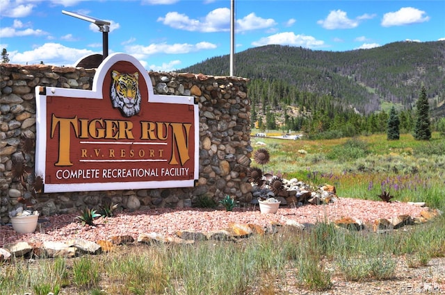 community sign with a mountain view