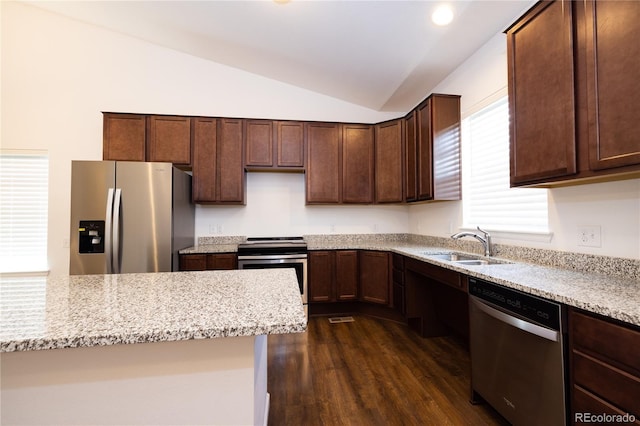 kitchen featuring dark hardwood / wood-style floors, lofted ceiling, stainless steel appliances, and a wealth of natural light