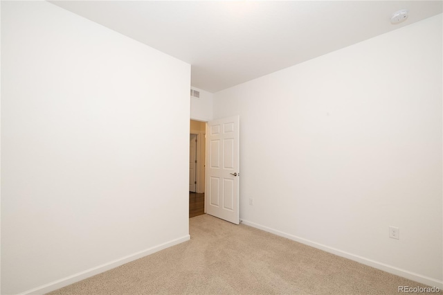 unfurnished room with light colored carpet