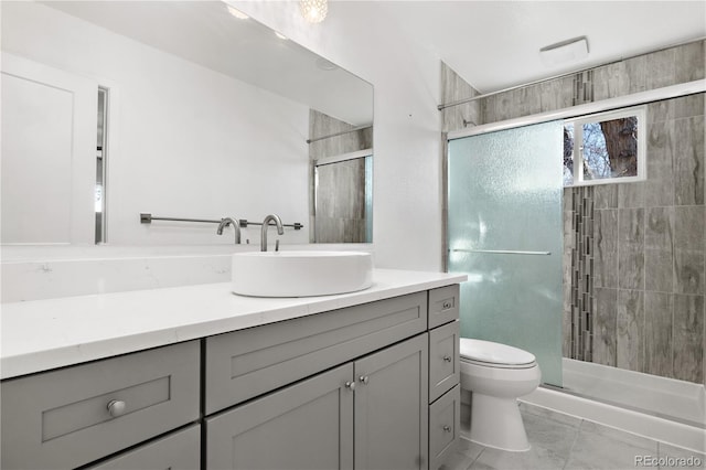 bathroom featuring vanity, toilet, and a stall shower