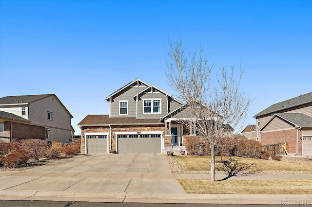 craftsman house with a garage, concrete driveway, and stone siding