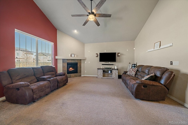 living room featuring ceiling fan, high vaulted ceiling, a tile fireplace, carpet floors, and baseboards