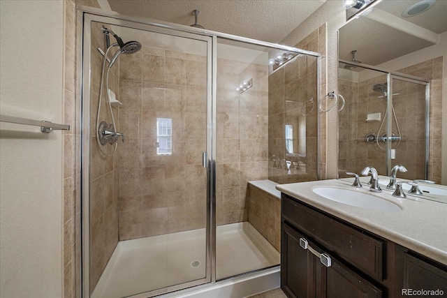 full bathroom with a stall shower and vanity