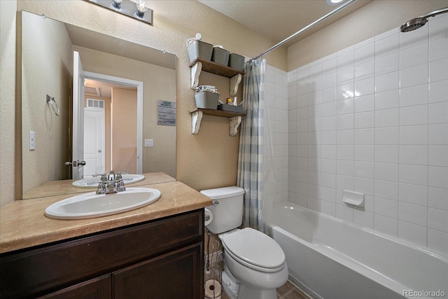 full bathroom with visible vents, a textured wall, toilet, shower / bath combo, and vanity