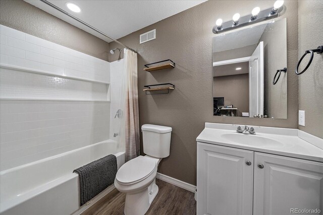 full bath with visible vents, toilet, wood finished floors, shower / tub combo with curtain, and vanity