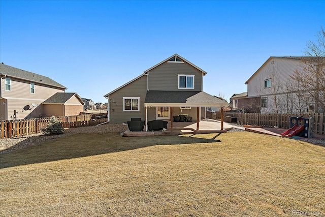 back of house featuring a fenced backyard, a patio, and a yard