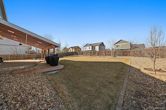 view of yard featuring a fenced backyard, ceiling fan, and a patio