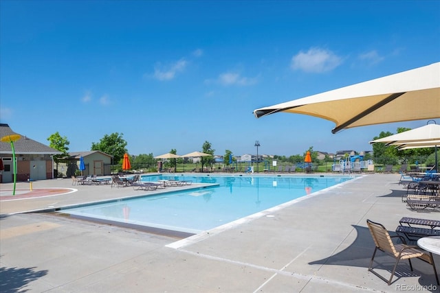 pool featuring a patio area and fence