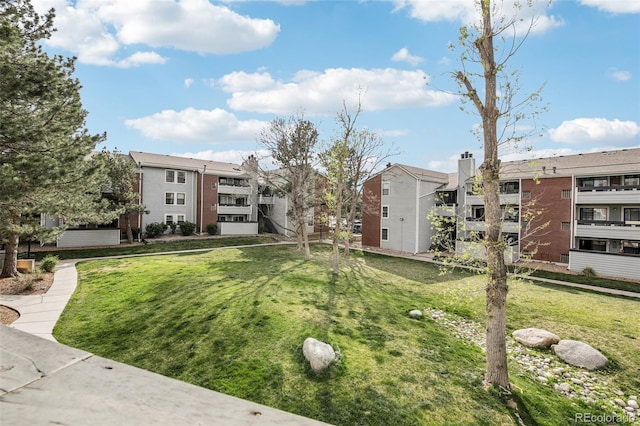 view of home's community featuring a residential view and a lawn