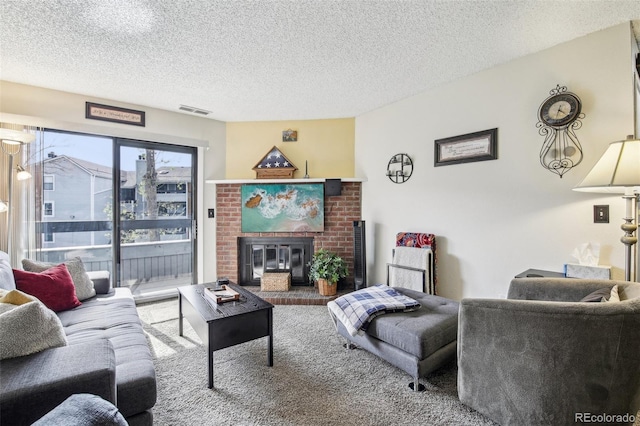 carpeted living room featuring a textured ceiling, visible vents, and a fireplace