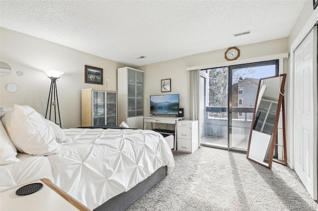 bedroom featuring visible vents, access to outside, a textured ceiling, and light colored carpet