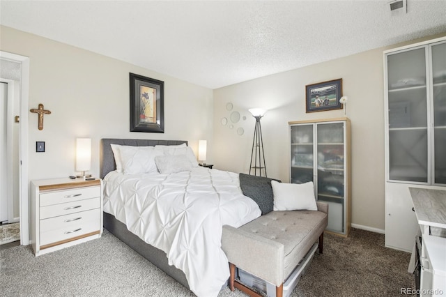 carpeted bedroom with visible vents, a textured ceiling, and baseboards
