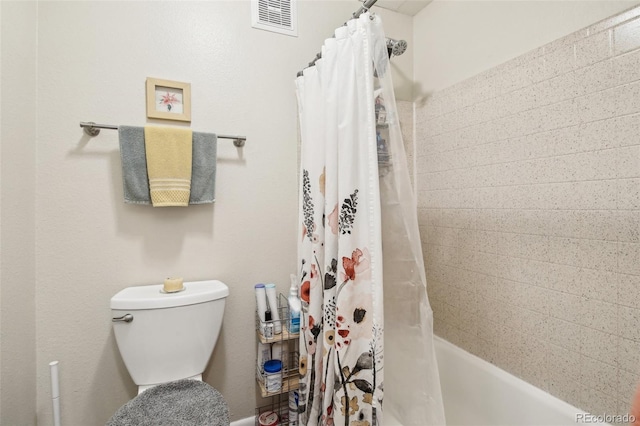 bathroom with visible vents, shower / bathtub combination with curtain, and toilet