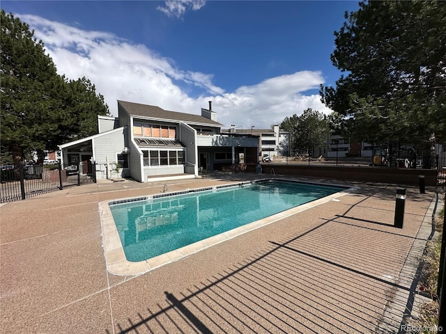 view of swimming pool with fence, a fenced in pool, and a patio area