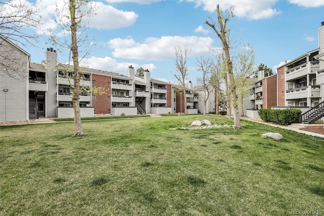 view of community with a residential view and a yard