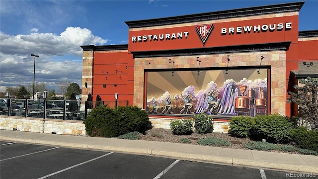view of building exterior featuring uncovered parking
