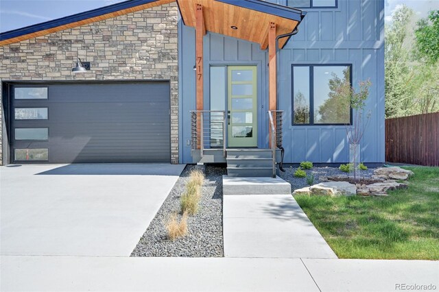 717 Marquette Ave, Buena Vista, CO 81211 - contemporary home featuring board and batten siding, stone siding, concrete driveway, and a garage