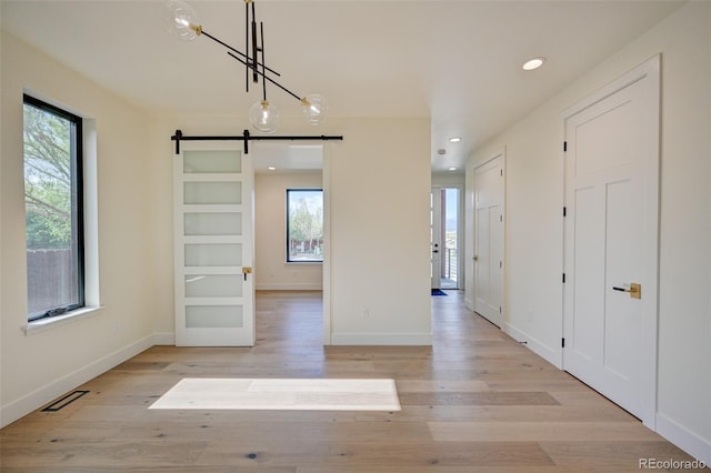 717 Marquette Ave, Buena Vista, CO 81211 - unfurnished dining area with a barn door, light wood-style floors, and recessed lighting