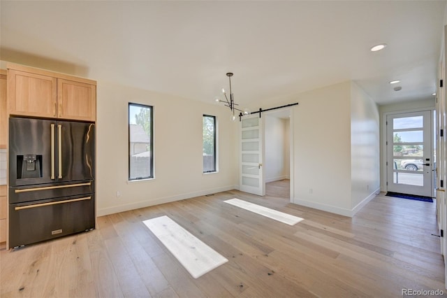 717 Marquette Ave, Buena Vista, CO 81211 - unfurnished dining area with a barn door, light wood-style floors, a chandelier, and recessed lighting