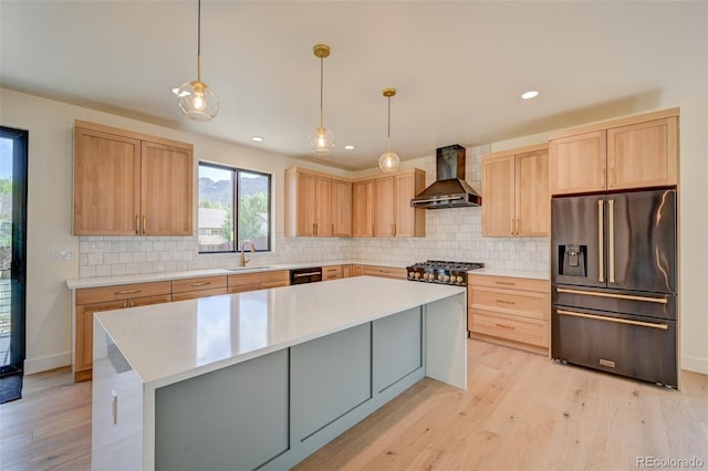 717 Marquette Ave, Buena Vista, CO 81211 - kitchen with stainless steel fridge, wall chimney range hood, light brown cabinets, backsplash, and recessed lighting