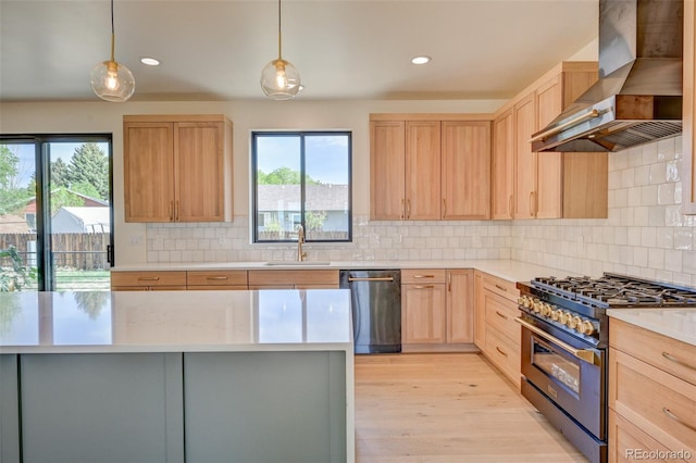 717 Marquette Ave, Buena Vista, CO 81211 - kitchen featuring wall chimney range hood, appliances with stainless steel finishes, light brown cabinets, light countertops, and backsplash
