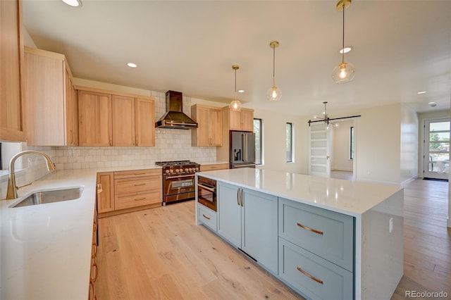 717 Marquette Ave, Buena Vista, CO 81211 - kitchen featuring high end appliances, wall chimney range hood, light brown cabinetry, backsplash, and recessed lighting