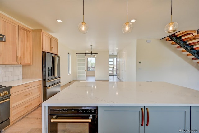 717 Marquette Ave, Buena Vista, CO 81211 - kitchen featuring stainless steel appliances, light brown cabinets, recessed lighting, light stone counters, and backsplash